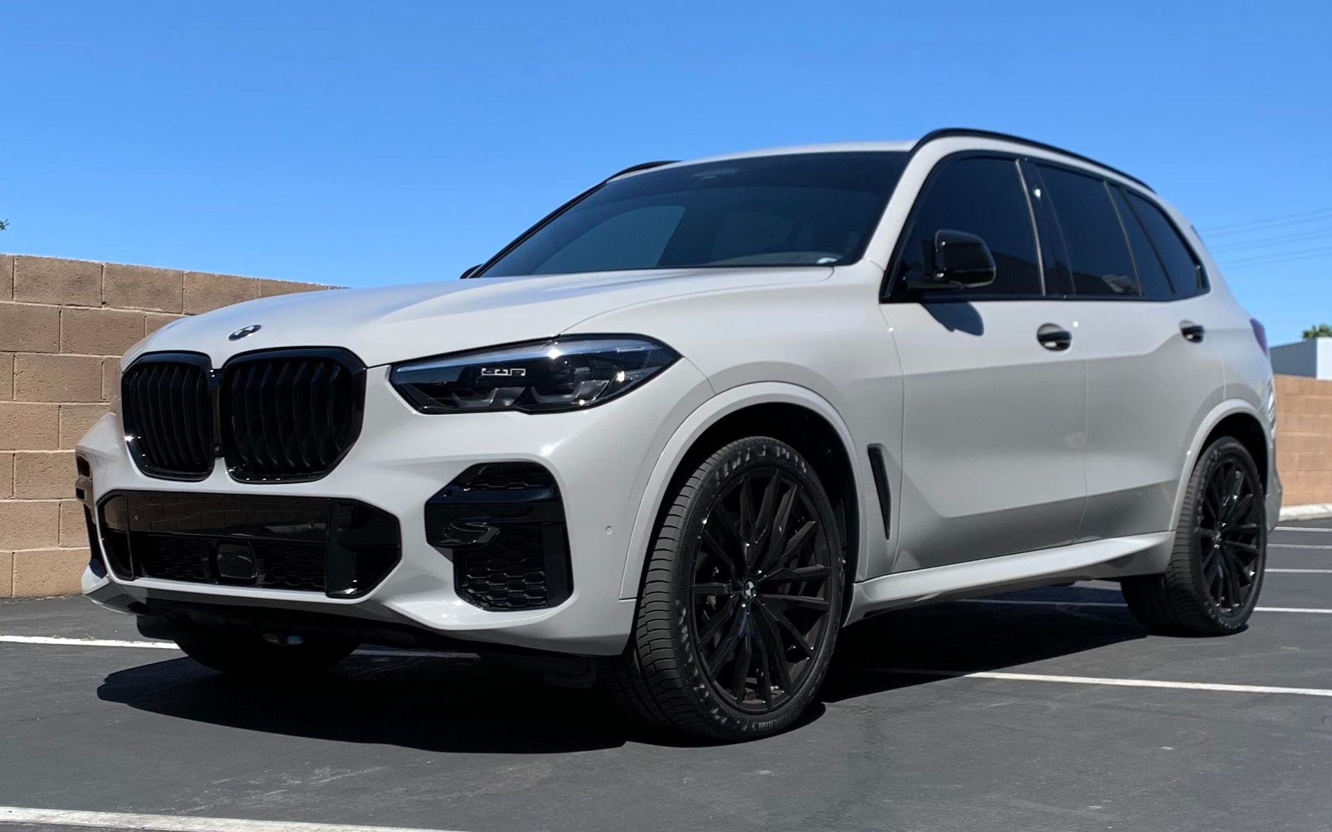 White BMW SUV with ceramic window tint and blackout wheels