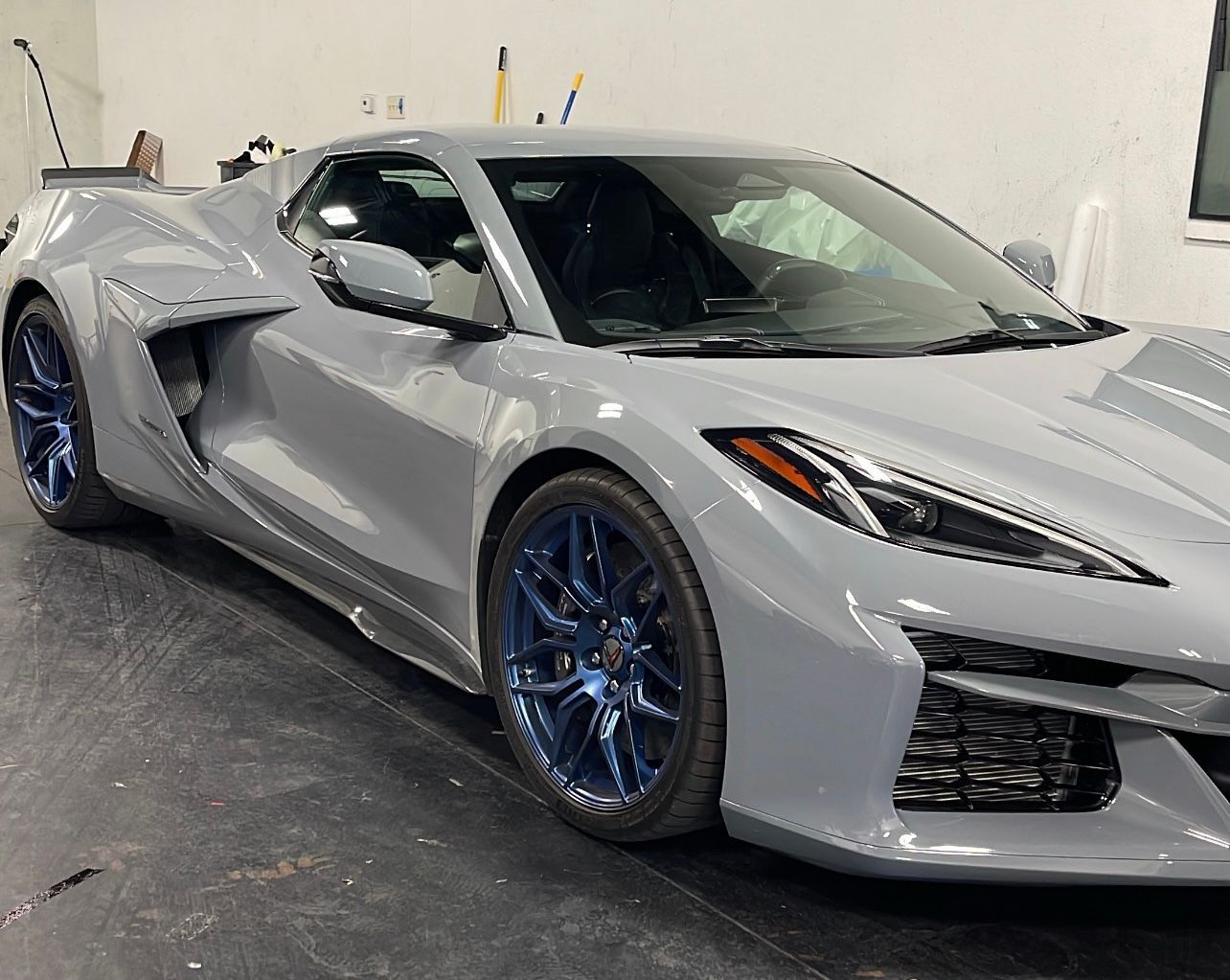 Silver sports car with electric blue custom powder coated wheels