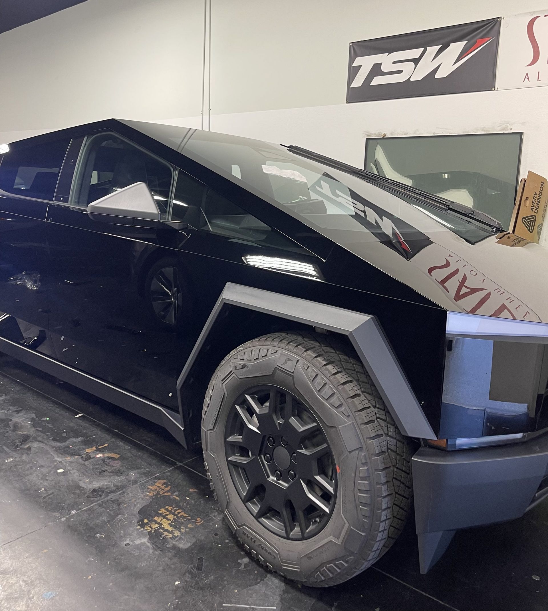 Custom lifted black pickup truck with aggressive custom wheels