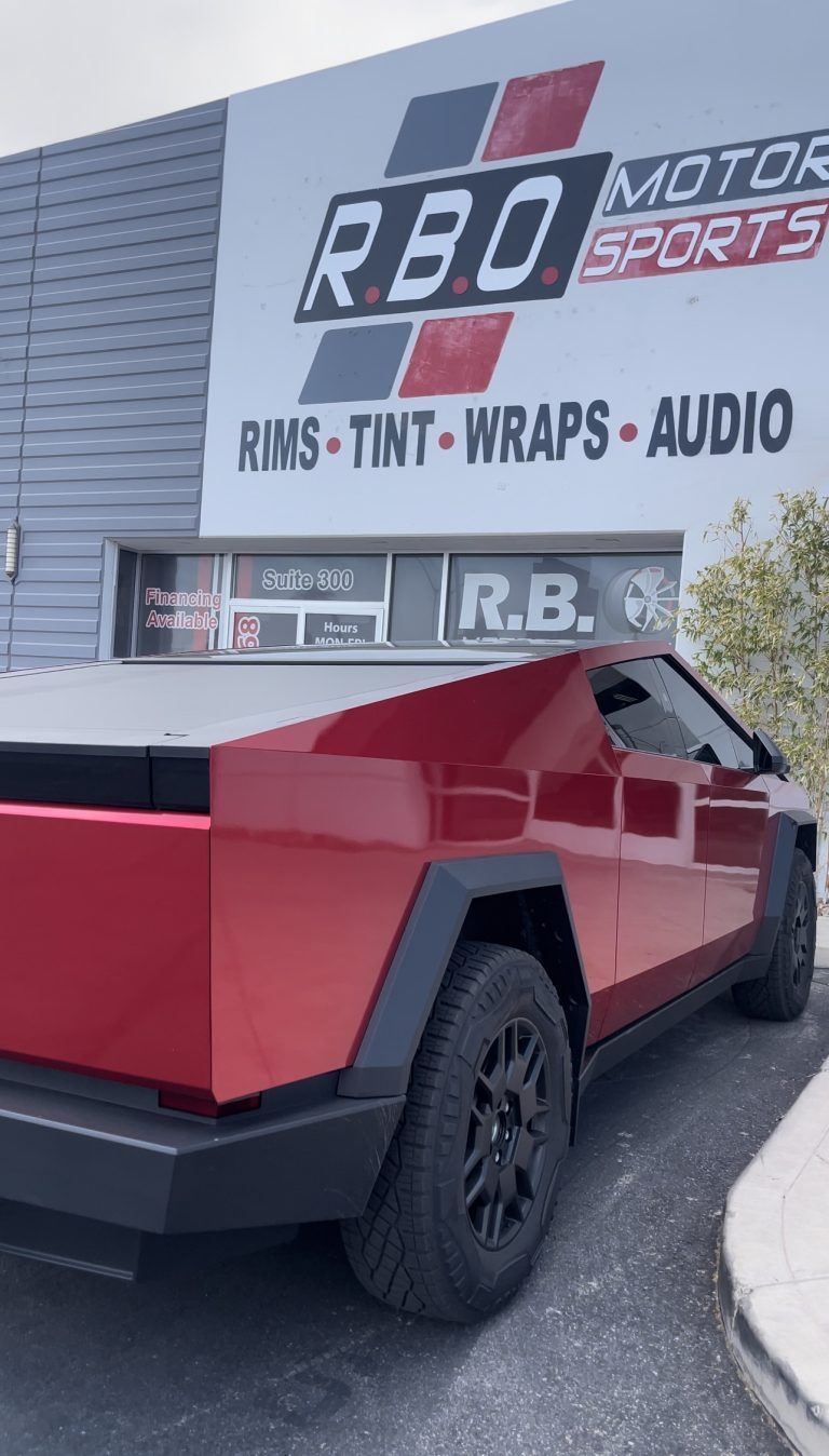 Red pickup truck outside RBO Motorsports shop